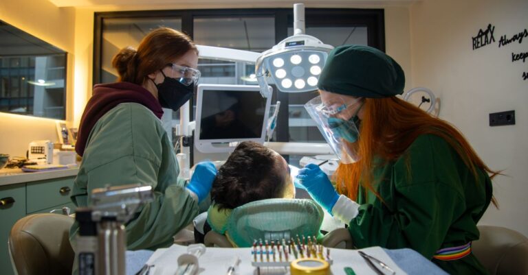 Dentysta prezentujący most adhezyjny pacjentowi w gabinecie stomatologicznym